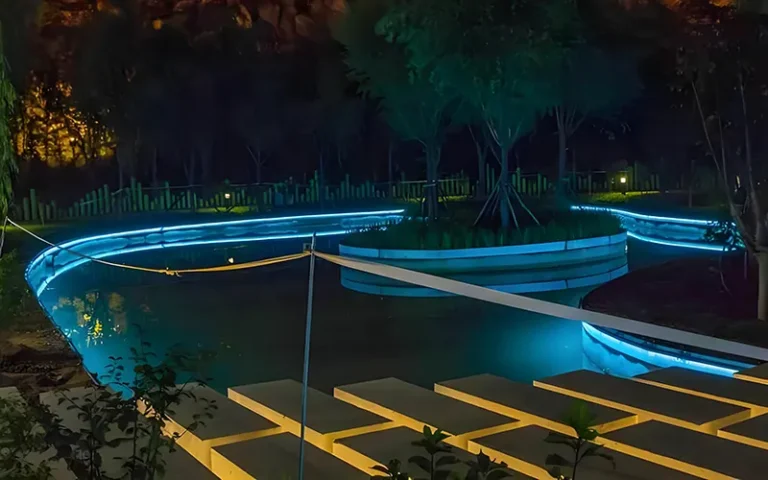 IP68 flexible neon strip lights installed around a modern swimming pool for waterproof outdoor lighting